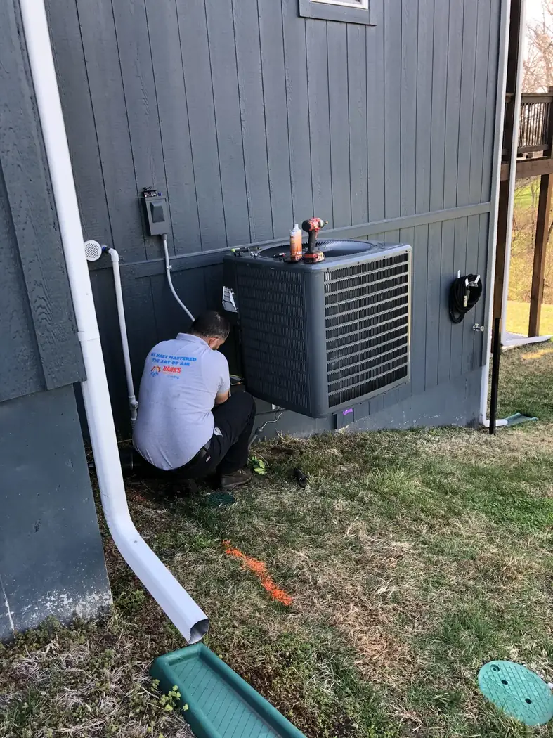 Haha’s technician installing residential air conditioning equipment in Kansas City