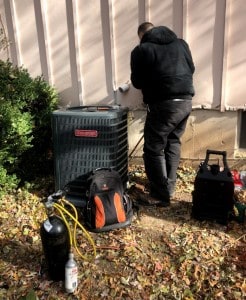 A technician installing a new AC unit in Kansas City, MO
