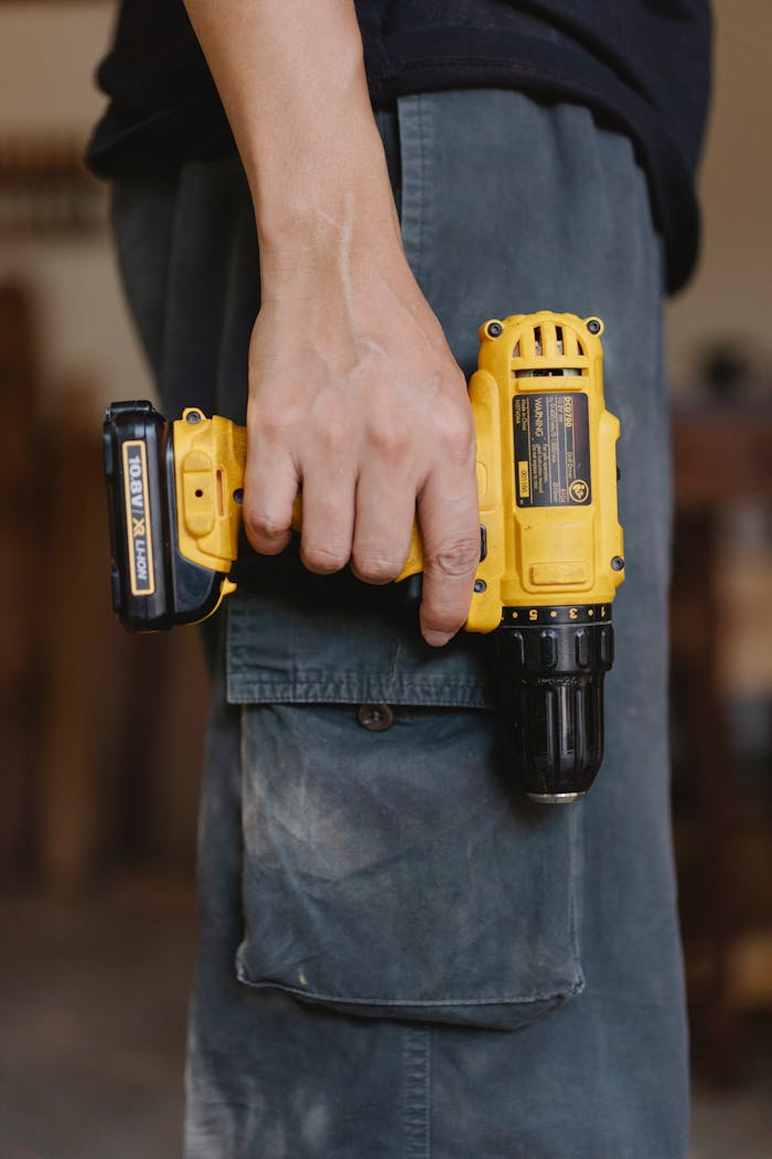 Man carrying a drill | Heating Repairs