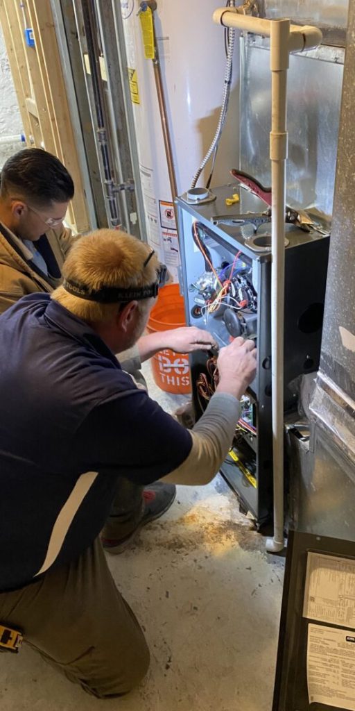 man working on furnace