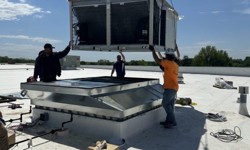 Men installing a rooftop HVAC unit | Heating Repairs