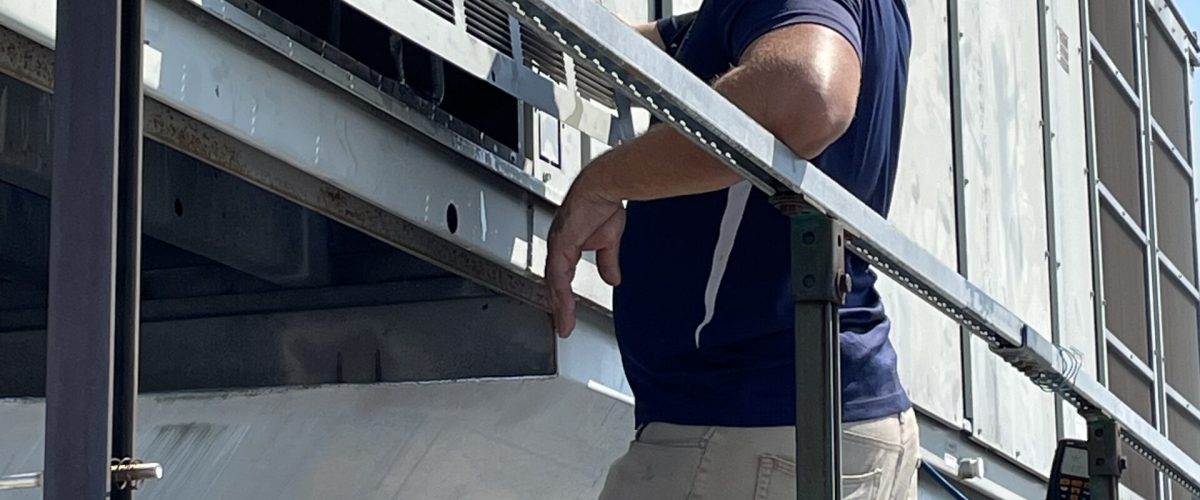 Technician in front hvac unit in kansas city, mo