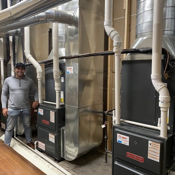tech standing next to installed furnace in kansas city